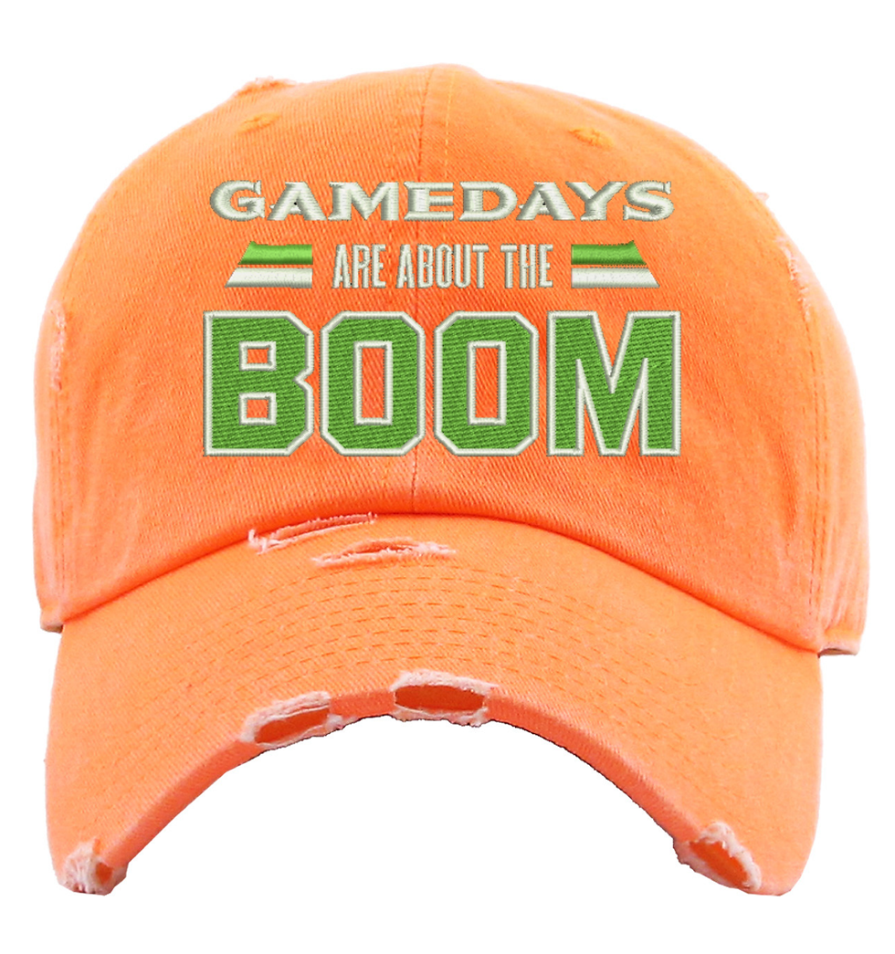 Orange distressed baseball cap with "Gamedays are about the Boom" text in green.