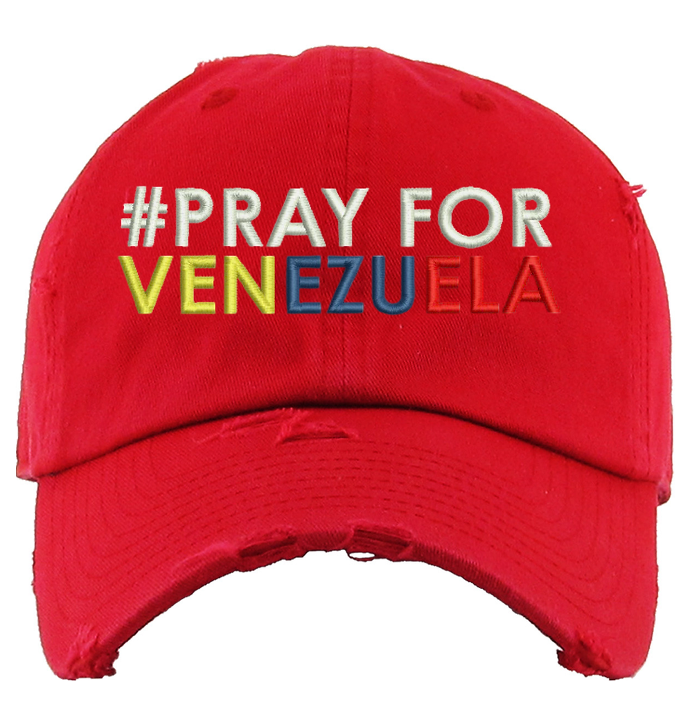 Red trucker hat with the words '#Pray for Venezuela' in colorful embroidery.
