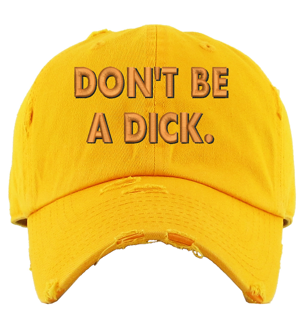 Yellow distressed baseball cap with the words 'Don't be a dick' in orange lettering.