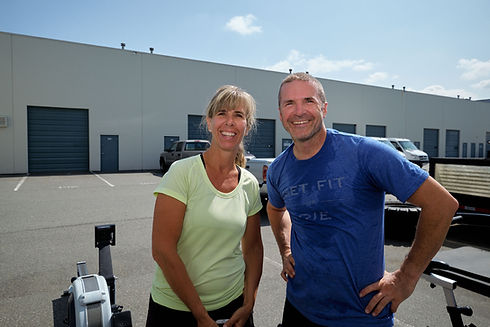 Woman and man standing together smiling outside of a gym
