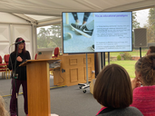 Marilyn behind a lecture speaking at the TCTC conference