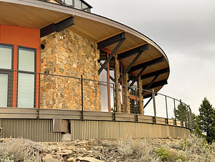 FORMation Architects project outside of deck overview of Railing Loomsystem mounted to curved deck with mountain home behind
