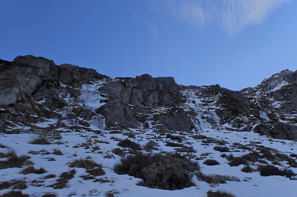 The Enticer, WI2/3, 80m. On the left, and another unclimbed flow on the right.