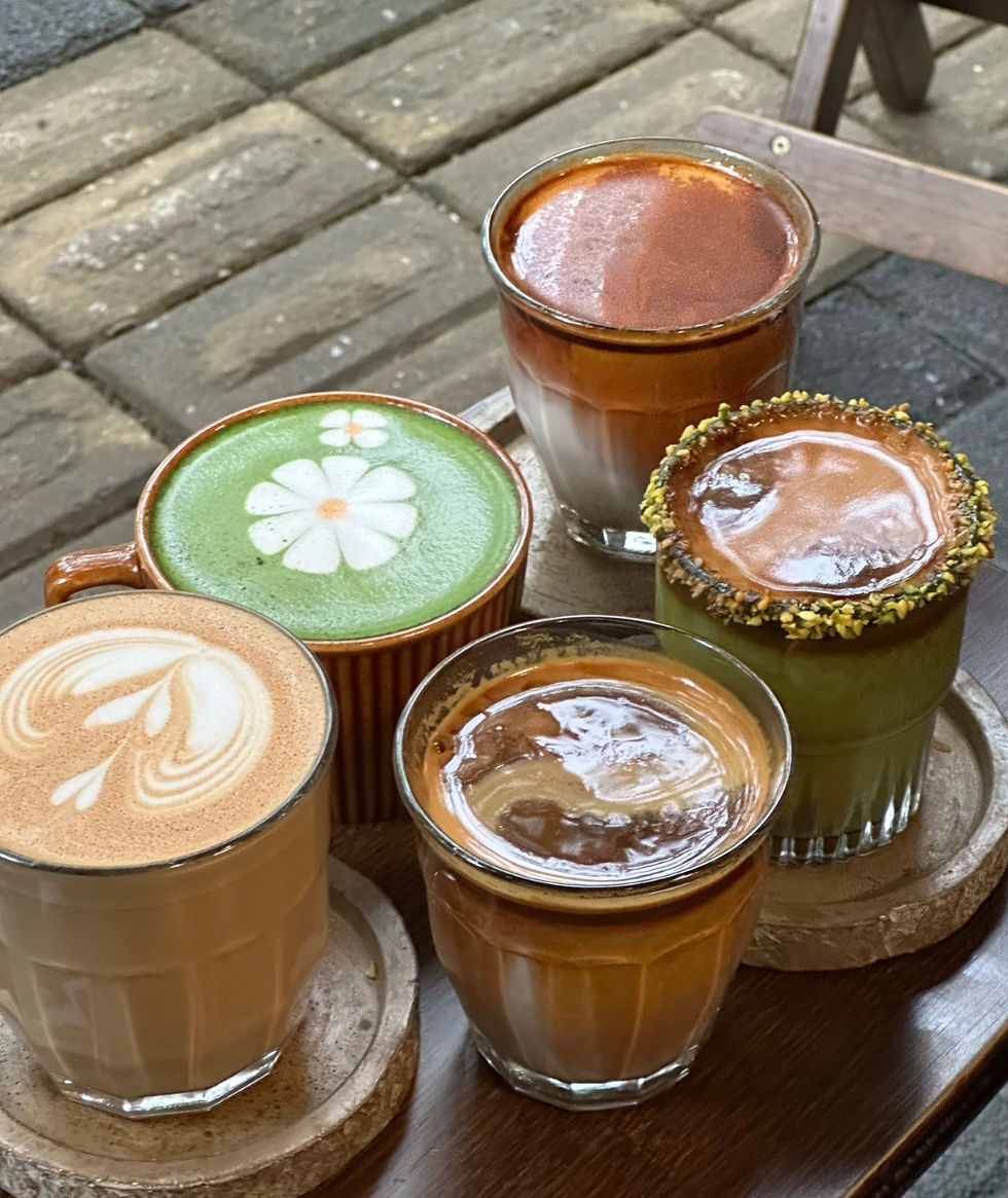 5 coffee famous in metal hands, including pistachio latte, latte, matcha latte, and vienna latte