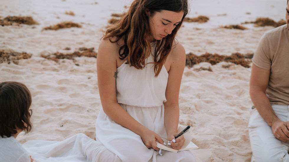 Woman journaling on the beach