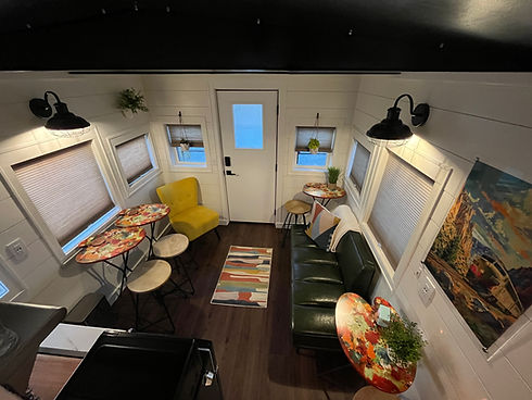 Cozy small living space with yellow chair and green couch