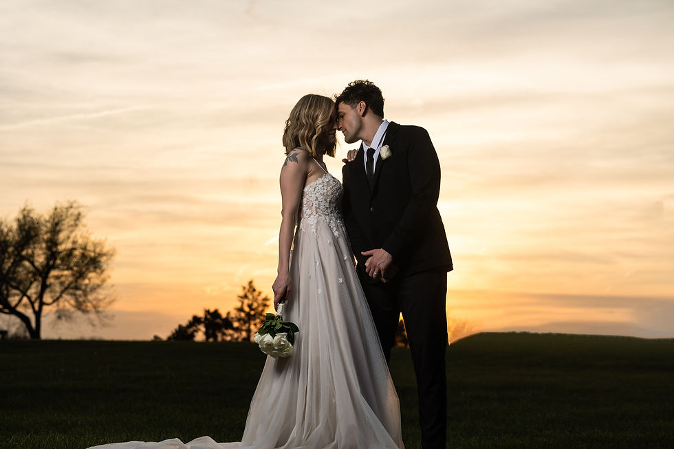Wedding couple kissing at sunset