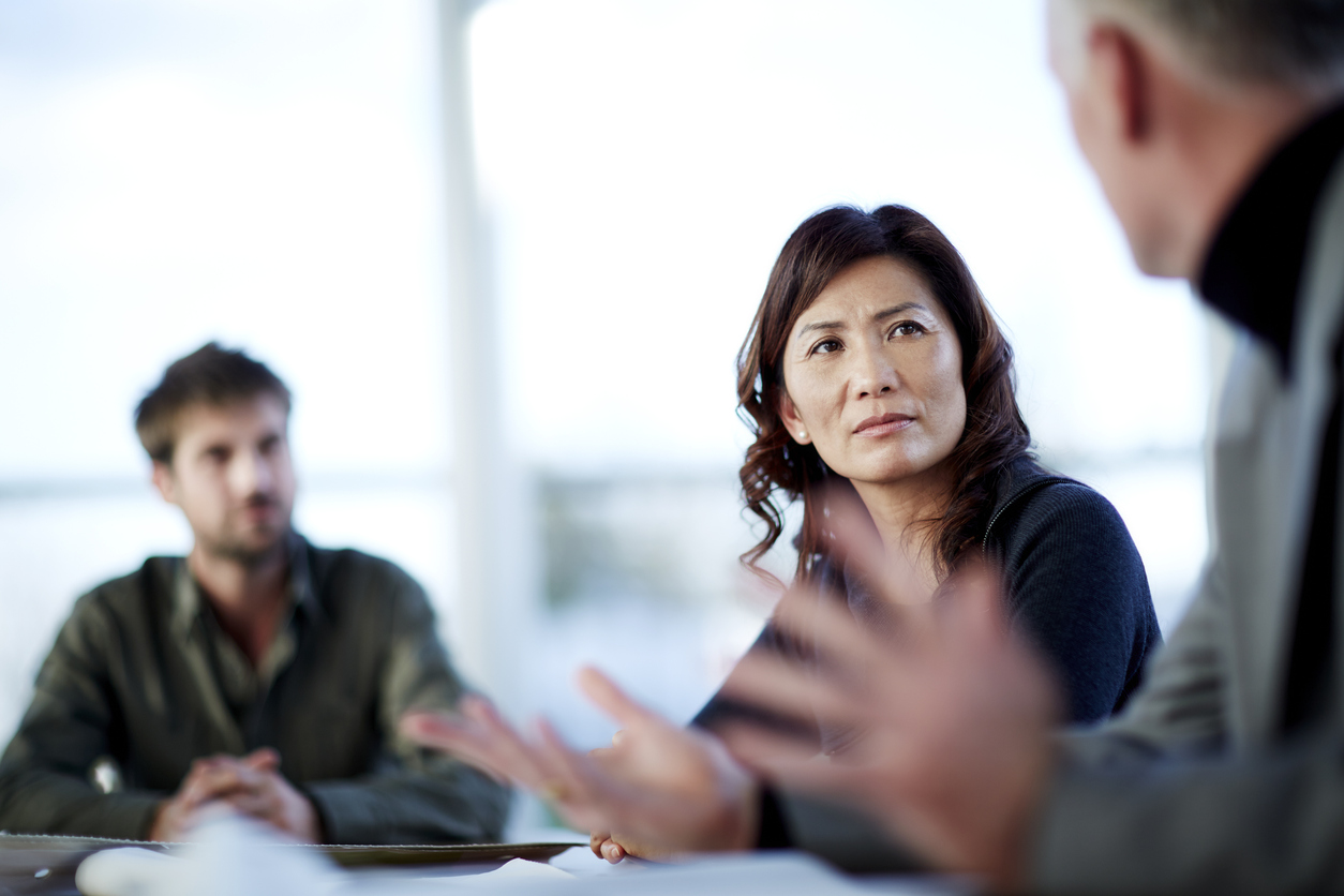 Three colleagues discussing business in the office