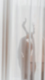 Siloutte of a woman dancing behind curtains