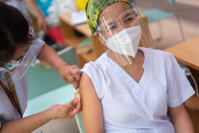 Nurse vaccinating nurse in Manila-.jpeg