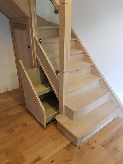 Bullnosed glass stairs with under stairs storage and .jpeg