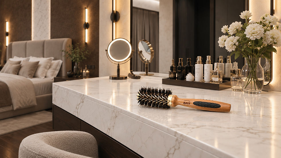 Bass Brushes Elegant bedroom vanity with marble counter, round mirrors, flowers, and a hairbrush labeled BASS in warm soft light