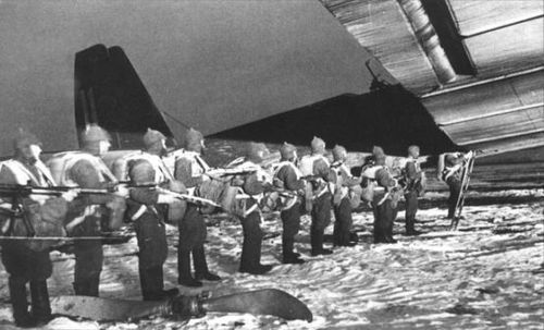 Soviet paratroopers in Budenovka hat boarding the plane
