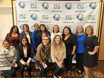 CSG female leaders pose for picture in front of CSG Banner