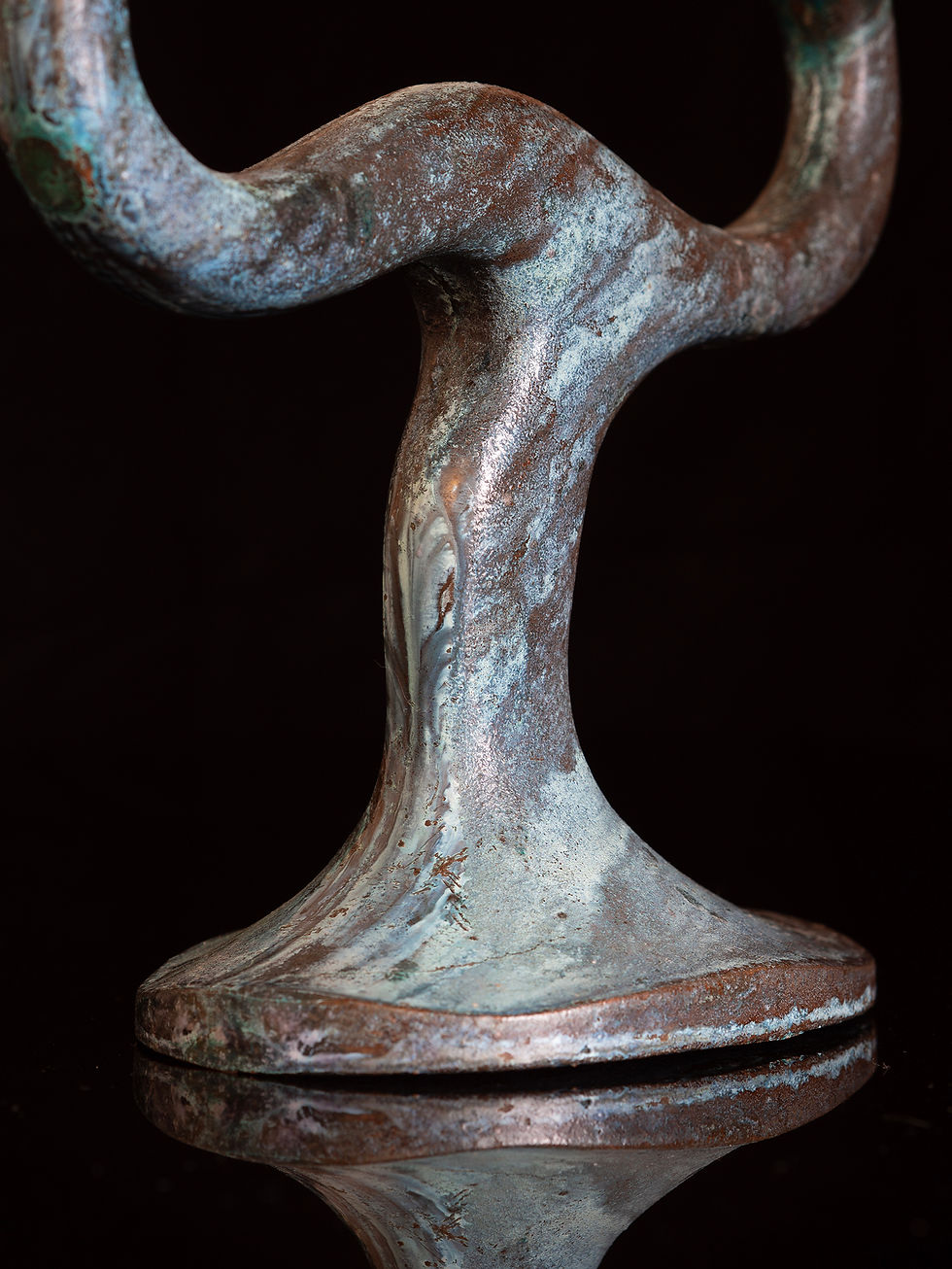 Thumbnail: A 2 arm candelabra with an organic, sinuous form cast in verdigris bronze
