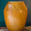 Thumbnail: very large mustard yellow floor vase with embossed decoration of dragon and phoenix across the top