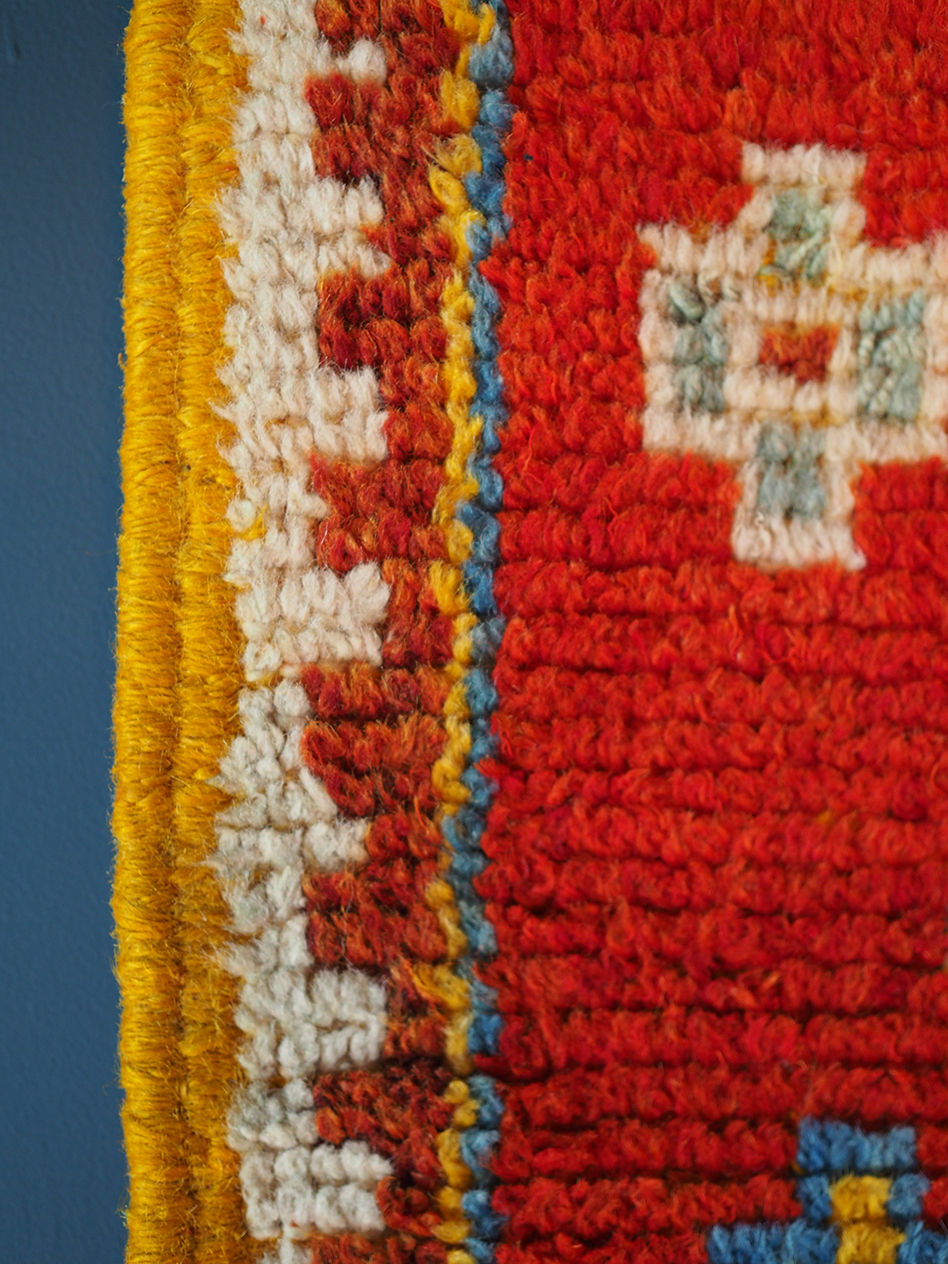 Thumbnail: A vintage moroccan Taznacht rug in deep red hues on a saffron ground