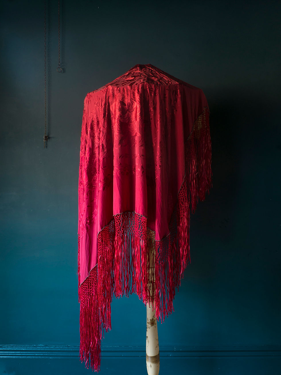 red silk chinese pano shawl draped over a large edwardian lampshade