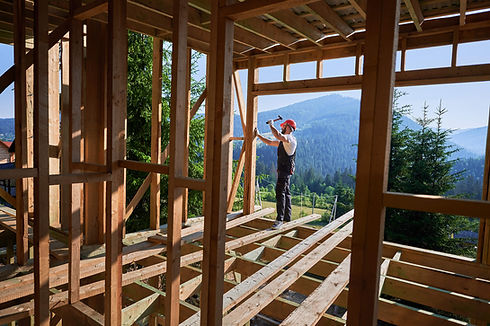 construction-worker-builds-wooden-house-in-mountai-2026-03-17-02-13-25-utc.jpg
