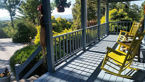 comfortable-porch-with-rocking-chairs-and-lush-vie-2026-03-24-04-55-40-utc.jpg