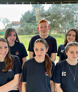 6 Youth Volunteers are in a group, wearing their FSC blue t-shirts