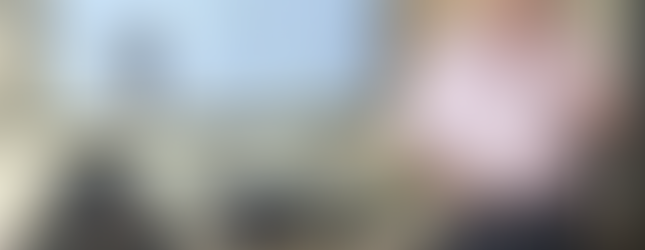 Man in a pink shirt presents in a meeting room, referencing a slide reading "People don’t care about how much you know…" Audience is attentive.