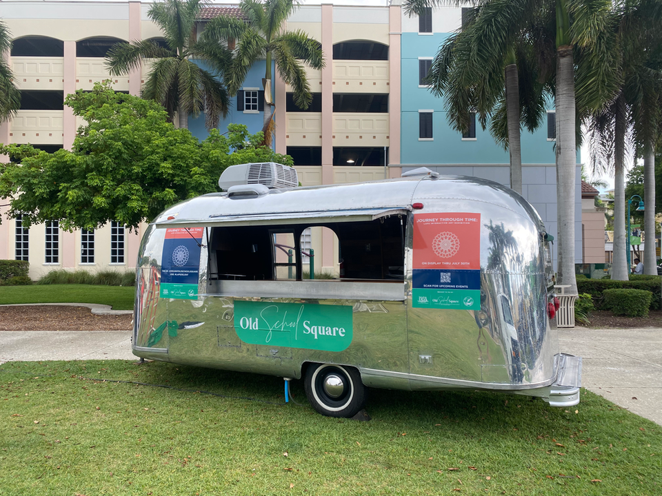A STARBAR Miami branded Airstream mobile bar parked at Old School Square market event in Delray Beach, Florida.