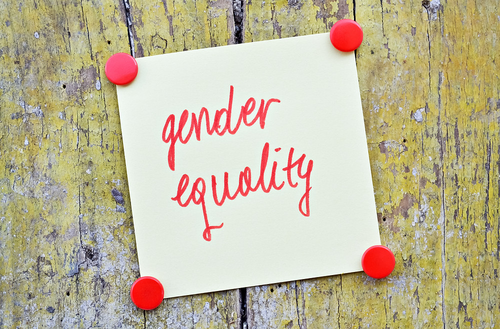 “Gender equality” written in red ink on a piece of paper tacked to wood