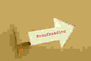 The word "proofreading" typed in red on white paper