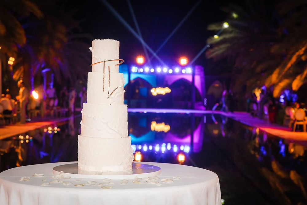 Gâteau de mariage blanc illuminé lors d'une soirée événementielle
