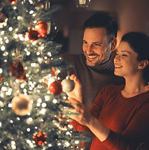 A lovely happy young adult married couple enjoying each others company and decorating the 