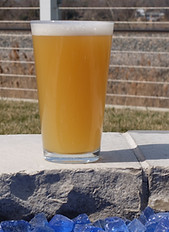 A pint of cloudy IPA outside on the patio.