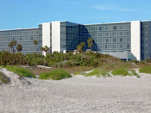 Oceanfront hotel construction site with cranes and steel framing along Atlantic coastline