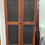 Thumbnail: Tall wooden cabinet with black panels