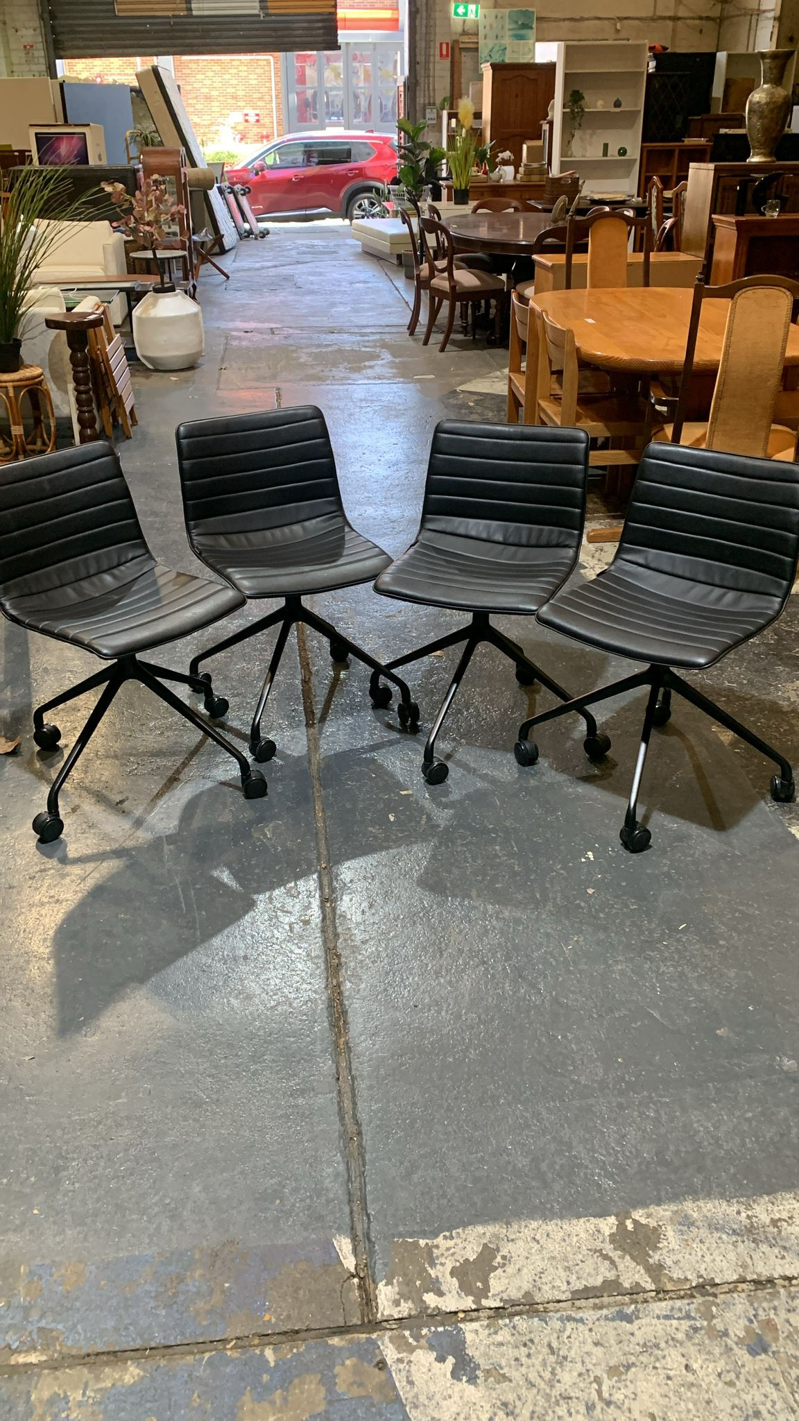 Set of 8 Black Ribbed Office Chairs on Castors