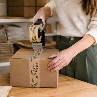 Parcel being sealed with branded printed tape