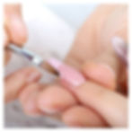 a nail tech painting a customers nails