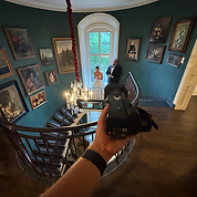 Wedding videographer filming indoors with professional camera