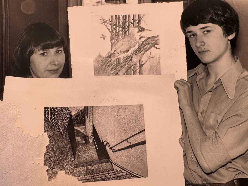 Elaine Marshall and her son Adam with an etching of a stairway and another etching of a woodpecker.