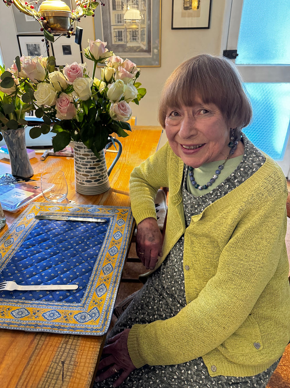 Elaine Marshall with flowers at a table.