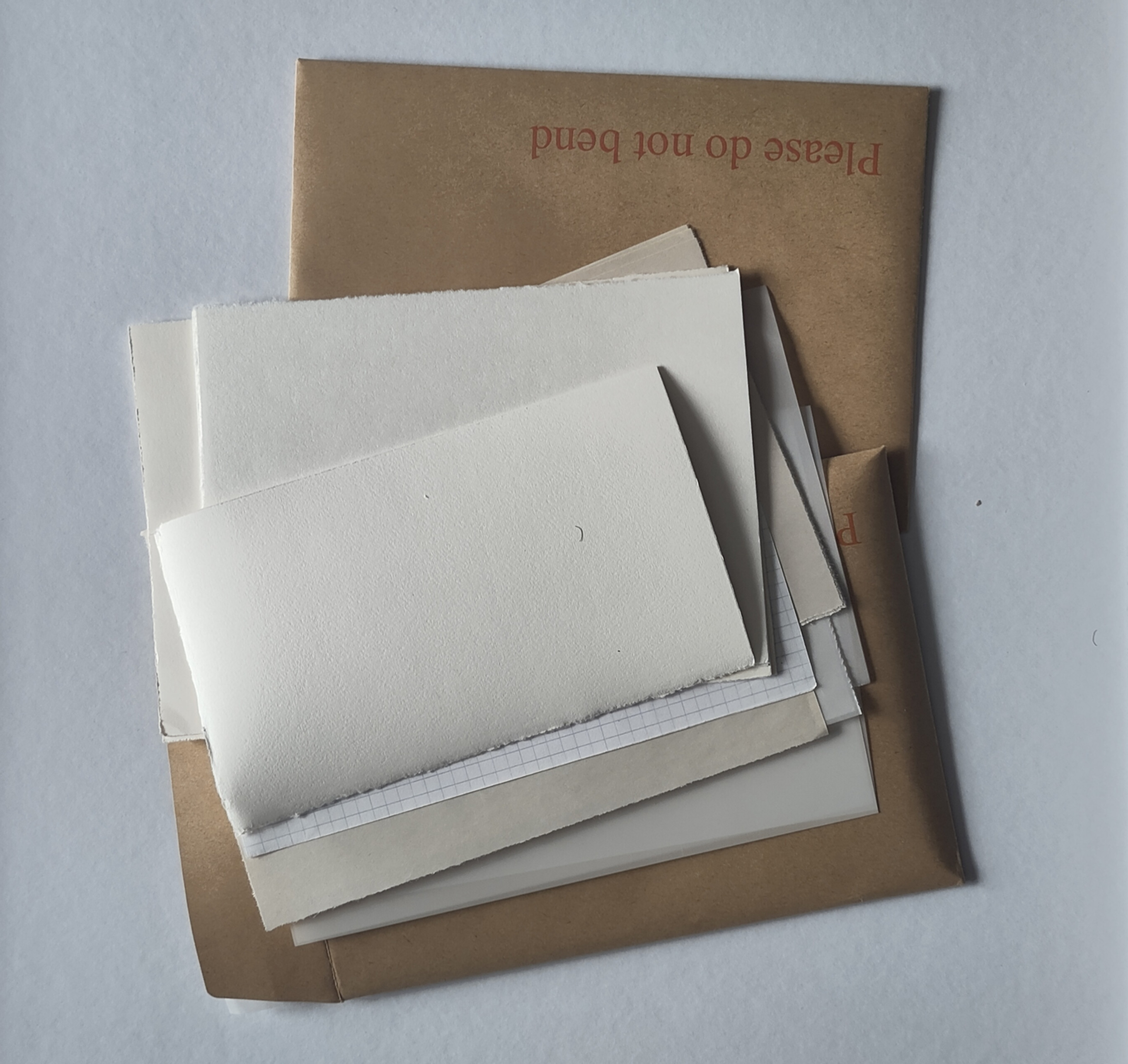 A collection of paper and an envelope marked "Please do not bend"