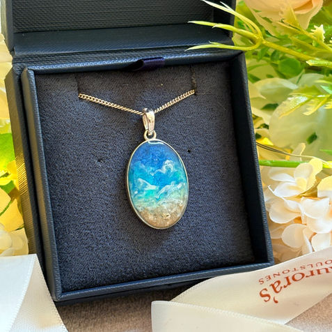 A beach scene cremation ashes pendant