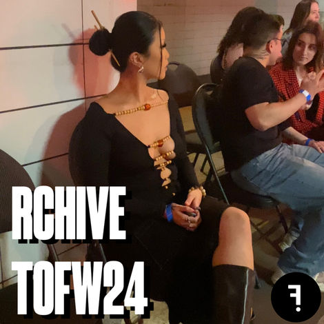 a woman sitting, dressed in black