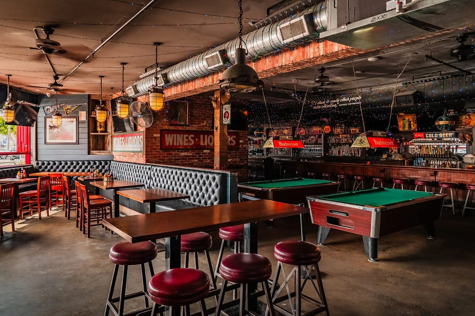Bar room with a pool table and high-top seating at Stag Bar + Kitchen in Newport Beach