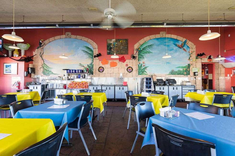 Dining room with painted murals and bright tablecloths at Blue Bonnet Restaurant in Denver