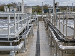 FRP vinyl ester versus stainless steel 316 in water treatment secondary infrastructure — pitting corrosion in free chlorine environments, hydrogen sulphide stress cracking in wastewater structures, 75% weight reduction, and 50-year lifecycle cost comparison across AMP8 UK water treatment and wastewater projects.