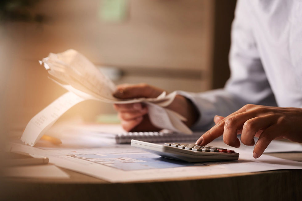 man using calculator while going through bills
