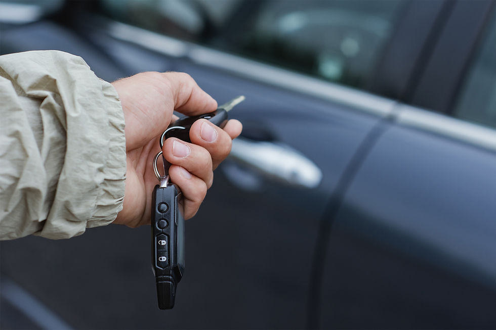 Hand holding car keys for an emergency locksmith Toronto.