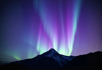 northern lights with purples, blues, greens, and pinks over mountain peak.jpg
