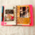 Pink Filofax planner open on a while cloth.